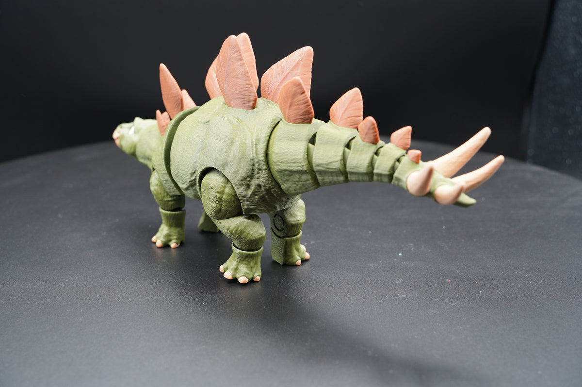 Articulated 3D printed Stegosaurus figurine - side profile view showing full body and iconic silhouette